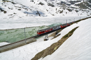 ABe 4/4 III 56 und 54 (verschandelt) ziehen einen Bernina-Express dem Lago Bionco entlang.